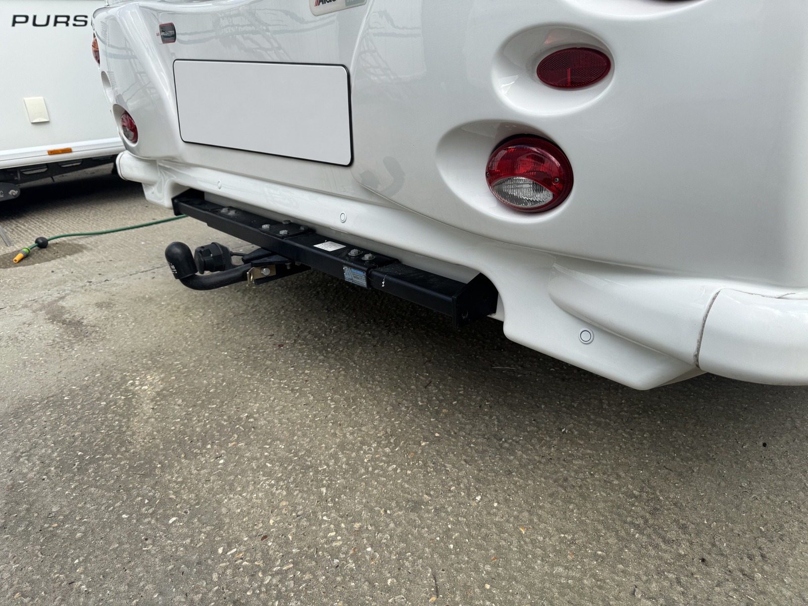 Rear of a white motorhome with wireless rear parking sensors fitted