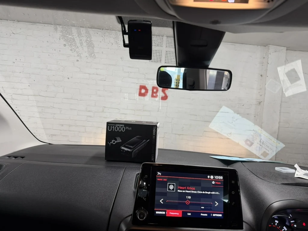 Dash camera fitted behind the mirror of a van